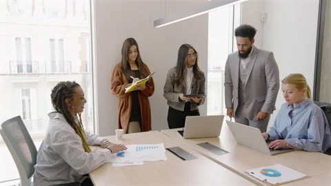 A Diverse Group of Individuals Collaborating in a Modern Office Setting for Stock Footage 305469603