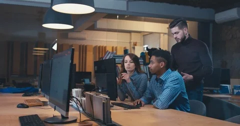 Diverse group of multiracial colleagues discussing a project on computer screen Video stock 83844178