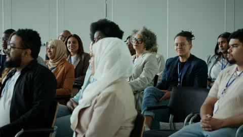 Diverse group of professionals actively listening and learning during a seminar Stock Footage 336530841