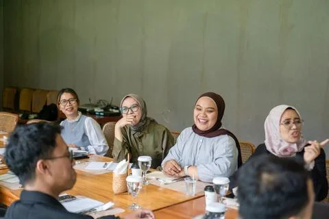Diverse group of professionals having a cheerful discussion during a meetin.. 스톡 사진