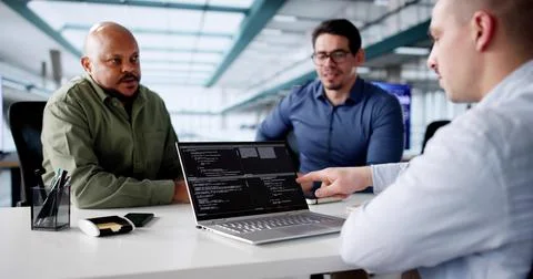 Diverse Group of Software Developers Coding on Laptops 写真素材
