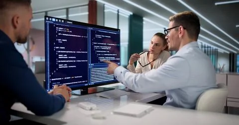 Diverse Group Of Software Engineers Coding Secure Data Together. Stock Photos