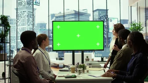 Diverse group of startup employees looking at green screen on interactive board Stock Footage 319468254