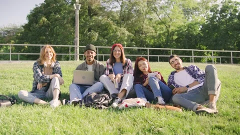 A diverse group of students smiles at the camera, Asian female in jeans and a Stock-Footage 283841033