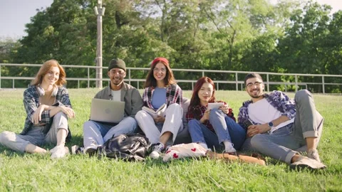 A diverse group of students smiles at the camera, Asian female in jeans and a Stock Footage 283841064