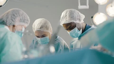 A diverse group of surgeons and nurses work together in a hospital Video stock 280110912