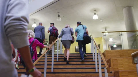 Diverse group of teachers and students in large modern university building Stock Footage
