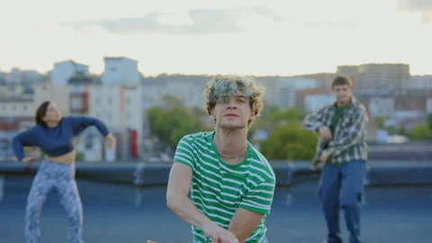 Diverse Group of Three Stylish Professional Dancers Dancing on the Roof. Young Stock Footage 239447994
