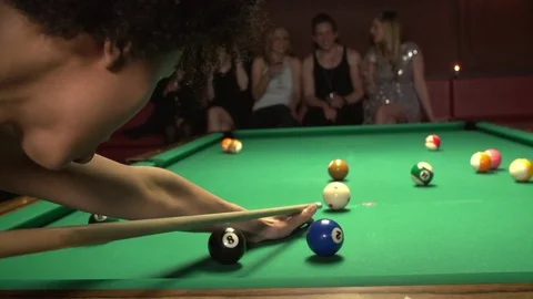 A diverse group of young and attractive friends playing pool at nightclub Stock Footage 82129686