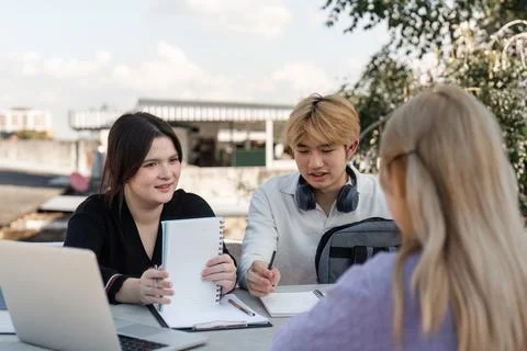 Diverse Group of Young Students Collaborating and Studying Together Outdoors Stock Photos