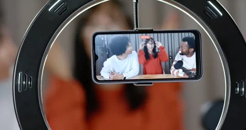 Diverse hosts seeing phone record light center host fixing specs others speaking Stock Footage 345607678