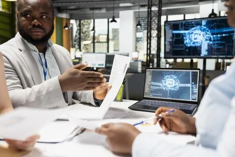 Diverse HR employees using AI neural networks to scan resumes Stock Photos