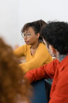 Diverse individuals sharing experiences in group therapy session Stock Photos