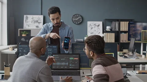 Diverse IT Developers Analyzing Dashboard on Laptop and Smartphone in Office 스톡 동영상 337483925