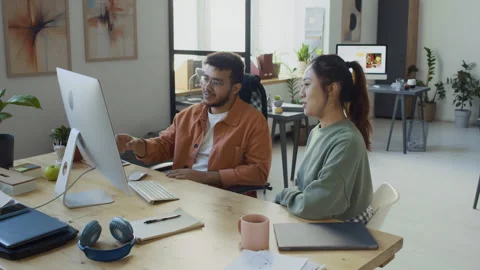 Diverse IT Engineers Bumping Fists After Testing New AI Software on Computer Stock Footage 293169983