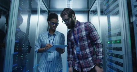 Diverse IT specialists with tablet in server room Stock Footage 97181991