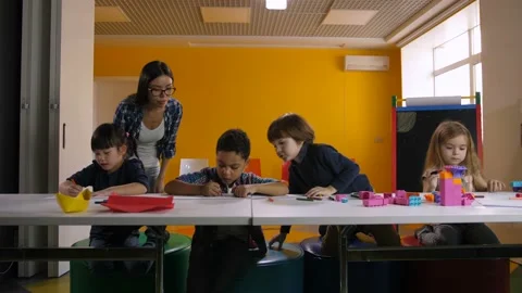 Diverse kindergarten pupils learning at classroom Stock-Footage 99841209