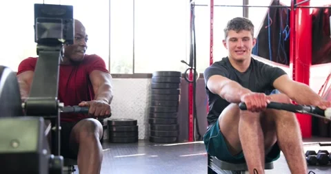 Diverse male trainer and trainee tapping handle signaling securing feet Stock Footage 335682858