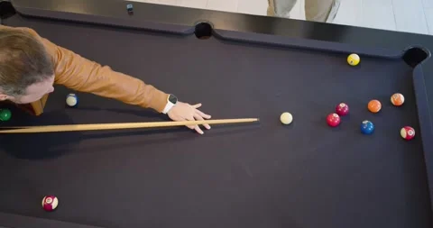 Diverse males playing pool, man in jacket lining, striking cue ball breaking Stock Footage 341953569