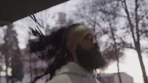 Diverse Man with Beard and Does Jumping Jacks Under Bridge at Sunset Stock Footage 270400343