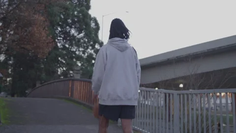 Diverse Man with Dreadlocks Walks Bouncing Basketball Downtown at Sunset Video stock 270399833