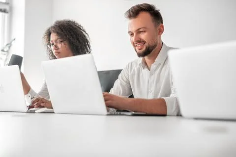 Diverse managers using netbooks in office Stock Photos