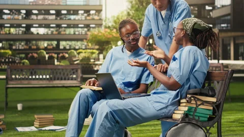 Diverse med school students learning together with coursework in group study Stock Footage 340961476