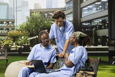 Diverse med school students learning together with coursework in group study Stock Photos