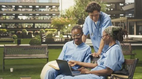 Diverse med school students learning together with coursework in group study Stock Photos