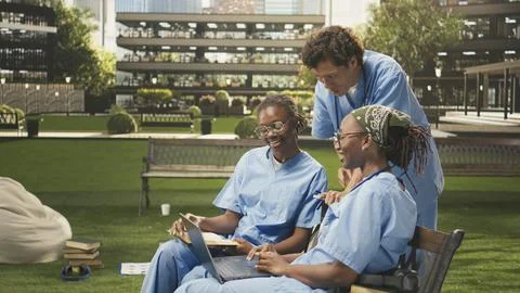 Diverse med school students learning together with coursework in group study Stock Photos