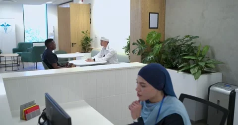 Diverse men discussing concern at table in reception, man gesturing causing Stock Footage 344326263