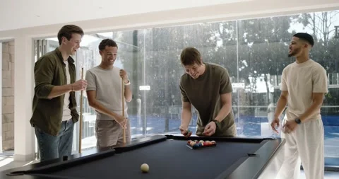 Diverse men gathering at black felt pool table, centered man placing rack, Stock Footage 339959627