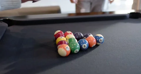 Diverse men racking balls at pool table to start game, African American man Stock-Footage 342033339