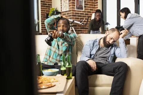 Diverse men react to losing video game tournament Stock Photos