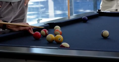 Diverse men watching shooter lining up and striking cue on pool table, rolling Stock-Footage 342084858