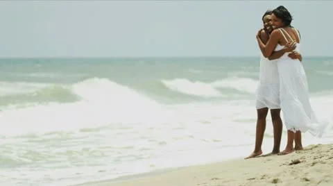 Diverse mother with happy daughter bonding together on beach Stock Footage