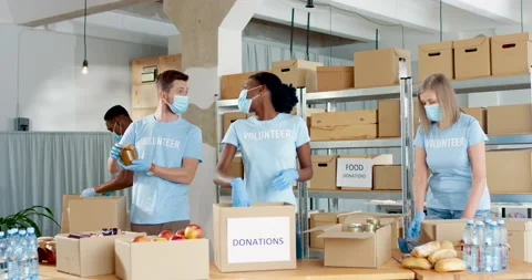 Diverse multi-ethnic young men and female working in warehouse in charity Stock Footage 152857849