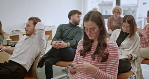 Diverse, multi generational team of professionals engaging in a lively Stock Footage 277296607