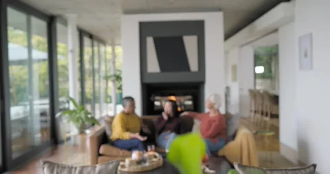 Diverse multigenerational women on sofa, camera pulling back from plant, Stock Footage 337287295