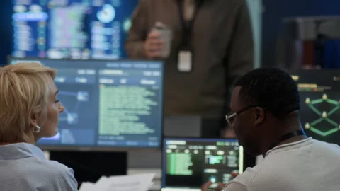 Diverse Network Engineers Communicating in Cybersecurity Room Stock Footage 334935650