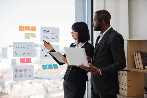 Diverse office workers checking data using electronic device 스톡 사진