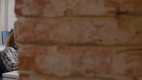 Diverse Office Workers Typing on Laptops and Talking at Desk Stock Footage 126136592