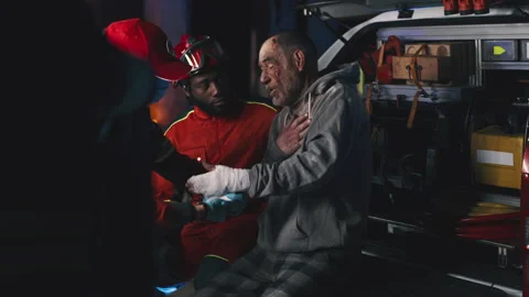 Diverse paramedics taking care of elderly patient Video stock 166146486