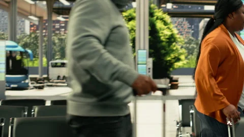 Diverse passengers walking through bus station waiting for long-haul journey Stock Footage 334729402