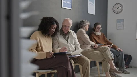 Diverse Patients Talking While Waiting in Queue in Modern Hospital Hall Video stock 332670129