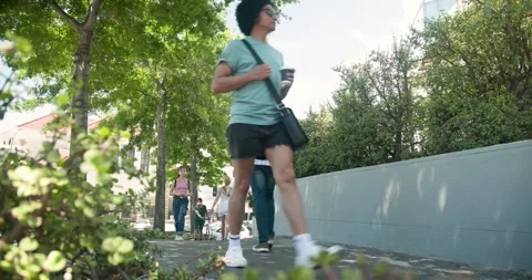 Diverse pedestrians walking uphill to shops on sidewalk, passing and pushing Stock Footage 344331232
