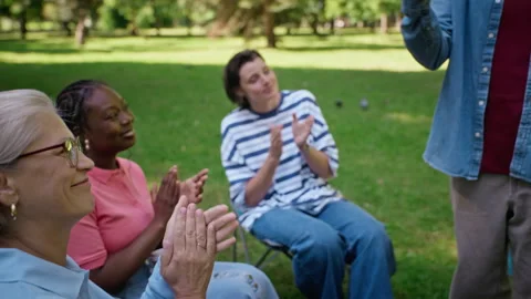 Diverse People Applauding Men Hugging at Outdoor Group Therapy Session Stock Footage 344950728