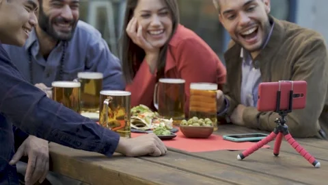 Diverse people having fun doing video call with friends brewery pub bar Stock Footage 168570994