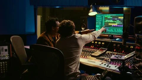 Diverse people processing and mixing sounds on audio console Stock Photos