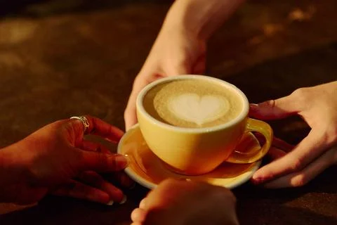 Diverse People Sharing Cup of Coffee with Latte Art at Cafe Stock Photos